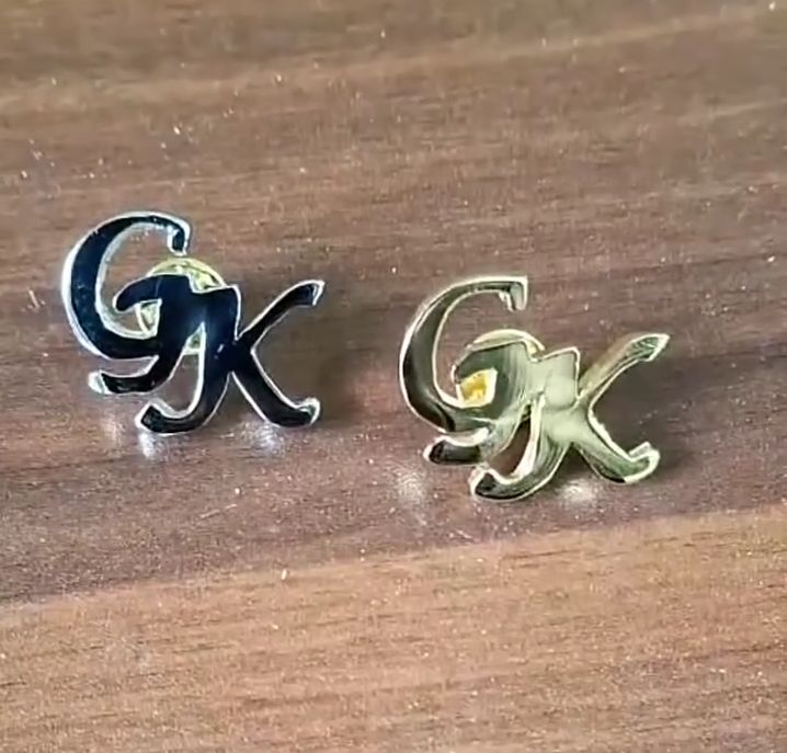 Custom metal lapel brooch set of his initials Kenya Juba Kampala Arusha